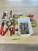 Assorted hand tools and accessories on tabletop