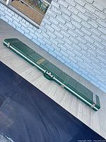 Full view of closed green hard case on floor