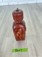 Front view of leather covered glass decanter