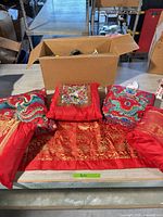 Lot overview showing three pillows and table runner