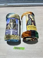 Both rolled throws with labels visible: Wolf and Madonna designs