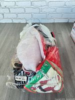 Bagged Santa suit parts showing red coat and hat