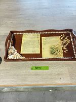 Full view of wooden tray showing seashell corner, laminated panels, glass cabochon border