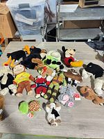 Overview of entire group of plush toys laid on table