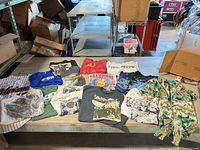 All fourteen shirts spread on table