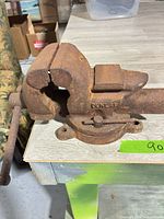 Side view of the rusted Dunlap bench vise on work surface
