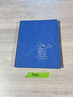 Front cover of blue cloth hardcover with Mickey Mouse outline