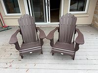 Front view of both brown composite Adirondack chairs on deck