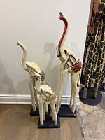 Front view of all three elephant sculptures showing relative sizes and paint details