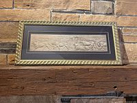 Full view of framed lion artwork on mantle