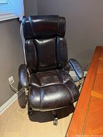 Front view of brown leather high-back office chair showing overall design and condition