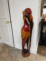 Front view of full wooden heron sculpture