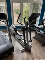Front and side view of Life Fitness X9i elliptical in room