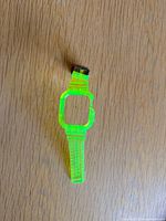Full view of neon green translucent Apple Watch band laid flat