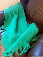 Oak + Fort bright green scarf draped on chair showing texture and fringe