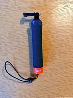 Full view of GoPro floating hand grip showing mount, grip and orange base