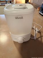 Front view showing Levoit branding, translucent tank, power cord