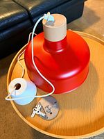 Red IKEA BUNKFELO pendant light with cord, canopy, mounting plate
