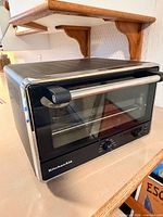 Front three-quarter view of KitchenAid toaster oven on counter