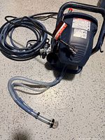 Pump unit with hose and suction tube visible