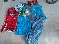 Group shot showing all Vancouver 2010 apparel, backpack, mittens, mug, scarf and brochures