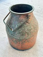 Full view of copper milk pot showing overall form and patina