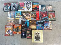 Overall view of all boxed games and spreadsheet package laid out on concrete