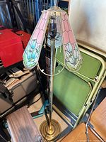 Full view of brass floor lamp showing damaged shade and missing panels