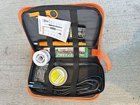 Overview of opened carrying case showing soldering iron and accessories