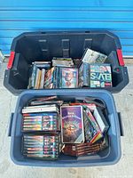 Two totes filled with numerous sealed DVDs and box sets