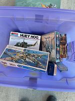 Tote containing Huey Hog model kit, sci-fi spacecraft kit, fighter jet kit, two small accessory boxes