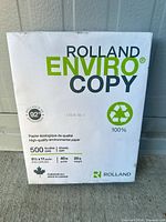 Front of sealed Rolland Enviro Copy paper ream showing specs 500 sheets, 8.5x11, 20 lb, 92 brightness, 100% recycled