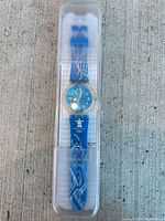 Full view of Swatch Vancouver 2010 wristwatch inside clear case