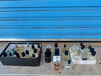 Group shot of all perfume bottles including black tray, center grouping and foam tray