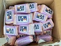 Top view of cardboard box showing numerous sealed packs of pet care wipes