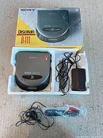 Box, Sony Discman D-111 unit, AC adapter, earbuds in plastic