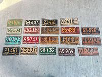 All sixteen BC licence plates laid out on concrete