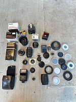 Group shot of all lenses, flashes, filters, boxes, and accessories arranged on floor