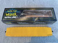 Top view of yellow Weaver boxcar alongside original Ultra Line box