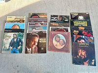 Overview of three stacks of country vinyl LPs laid out on ground