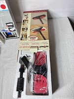 Scunci steamer accessory kit open in foam tray showing pads, hose, handle and box