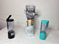 Three blenders arranged: black, boxed Ninja Blast Max, turquoise BlendJet