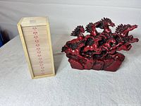 Figurine and wooden box side by side