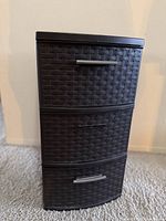 Front view of three-drawer plastic weave storage tower