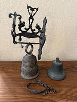 Bracket, two bells and clamp displayed on tabletop