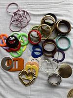 Full lot showing bangles, belt buckles and metal pieces on cloth background