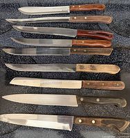 Eight knives laid flat showing full profiles