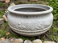 Front angle of grey planter showing flared rim and relief leaf detail