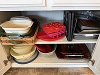 Full cabinet view showing entire assortment of bakeware and kitchenware