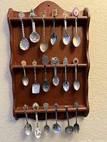 Full view of wooden rack with all spoons displayed
